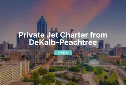 Jetbay private jet charter services from DeKalb Peachtree Airport with Atlanta skyline at sunset