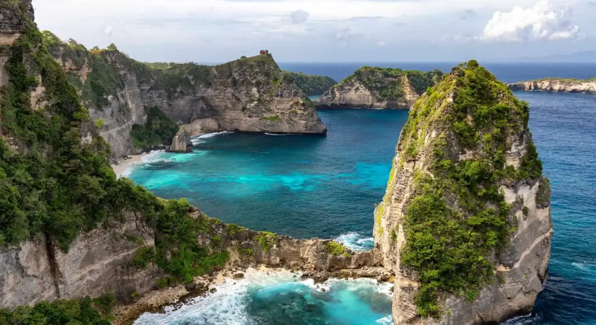 Dramatic limestone cliffs and turquoise coves of Bali's coastline, a luxury private jet charter destination from Jakarta
