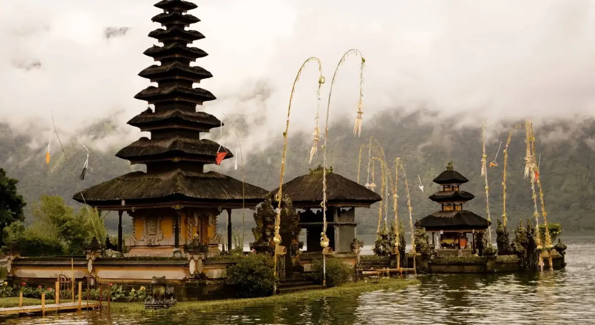 Ulun Danu Beratan temple rising from misty Lake Bratan in Bali, a premier luxury private jet destination in Indonesia