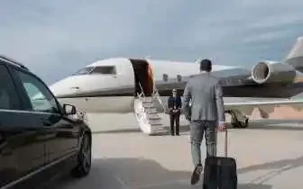 Business private jet charter for executive travel in Indonesia featuring businessman walking towards a private jet