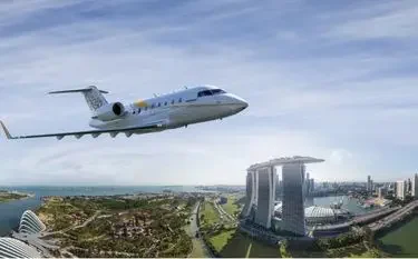 Private Jet Charter to Singapore Seletar Airport (XSP/WSSL) Private jet flying over Singapore's Marina Bay Sands and Gardens by the Bay, representing luxury charter flights to Seletar Airport with Jetbay