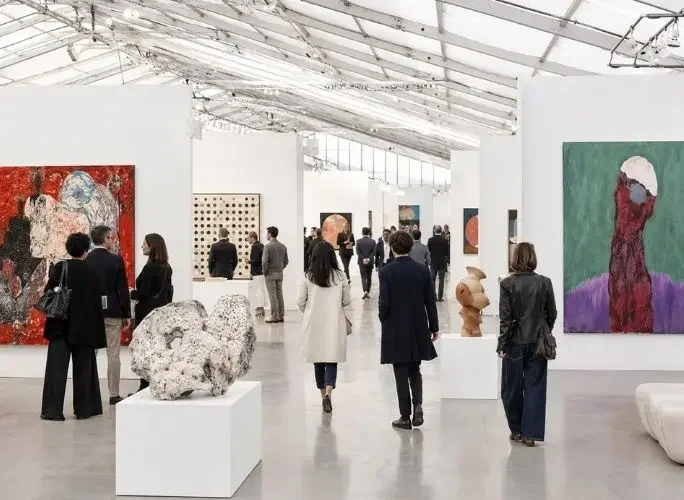 Collectors browsing contemporary paintings and sculptures at Frieze London art fair
