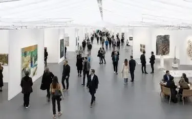 The Complete Guide to Frieze London on a Private Jet Guests browsing contemporary artworks inside the Frieze London art fair pavilion