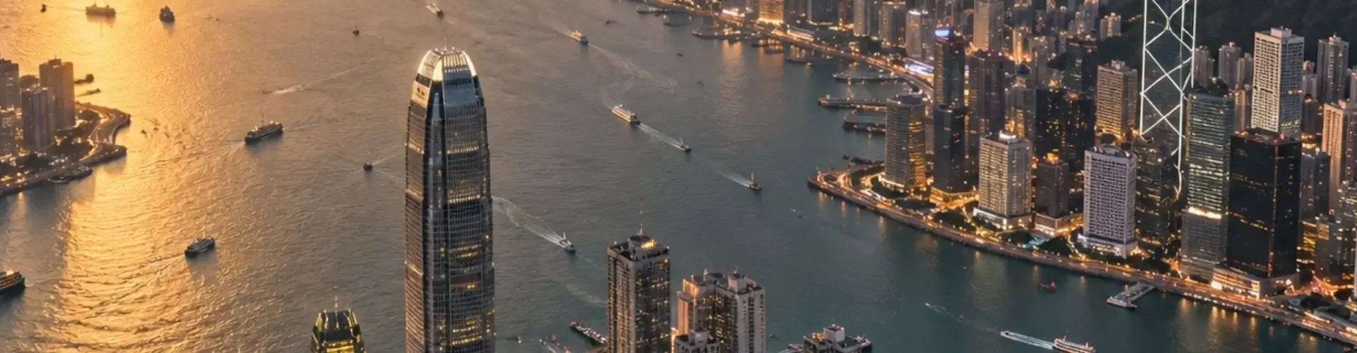 Private Jets for Every Type of Travel from Hong Kong Aerial view of Hong Kong's Victoria Harbour skyline at golden hour, a premier destination for private jet charter travel
