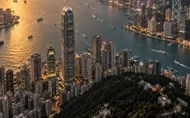 Private Jets for Every Type of Travel from Hong Kong Aerial view of Hong Kong's Victoria Harbour skyline at golden hour, a premier destination for private jet charter travel