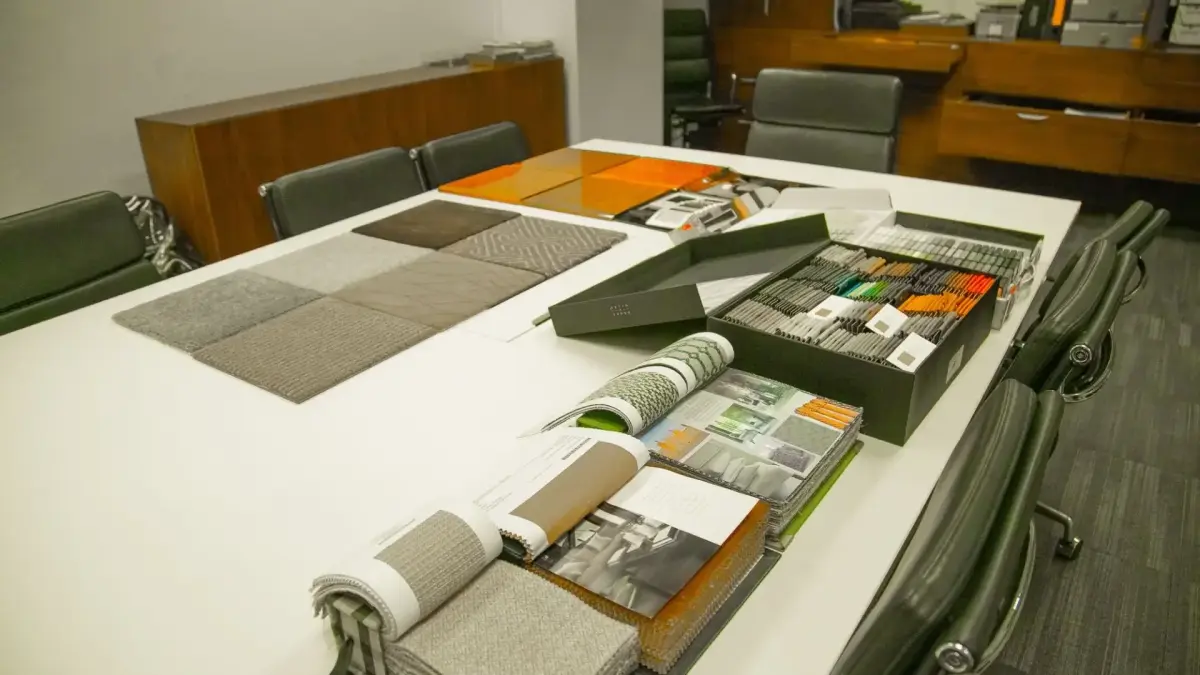 Luxury fabric and material samples displayed on conference table during private jet customization consultation