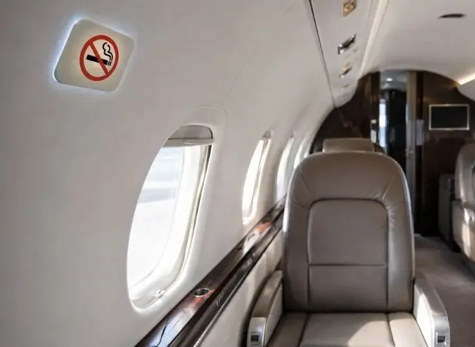 Business jet showing no-smoking sign illustrating onboard smoking restrictions