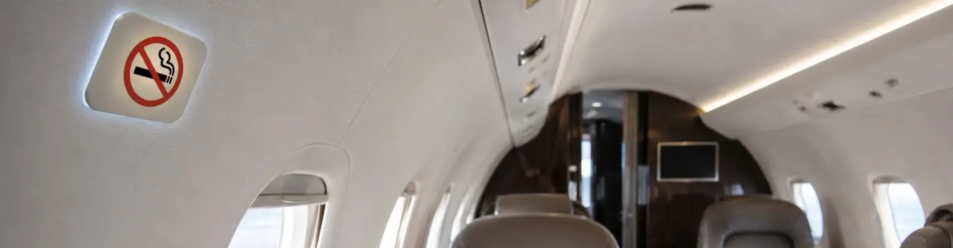 Can You Smoke on a Private Jet? Cigarettes on Commercial vs Private Flights No-smoking sign inside a private jet cabin showing onboard smoking restrictions