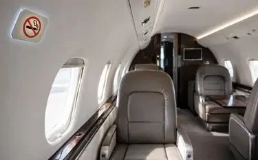 Can You Smoke on a Private Jet? Cigarettes on Commercial vs Private Flights No-smoking sign inside a private jet cabin showing onboard smoking restrictions