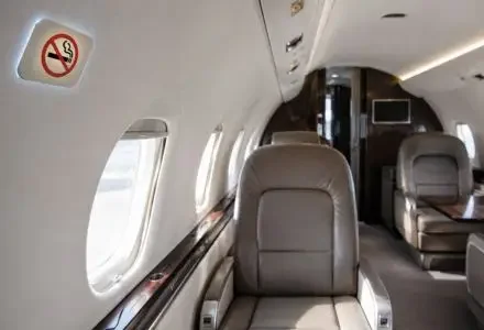 No-smoking sign inside a private jet cabin showing onboard smoking restrictions