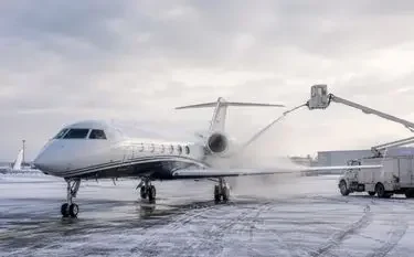 Private Jet Deicing: A Practical Guide for Charter Clients Private jet undergoing deicing before winter departure on a snowy airport apron