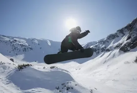 Skier enjoying powder snow in Italian Alps mountains for 2026 Winter Olympics private jet travel guide