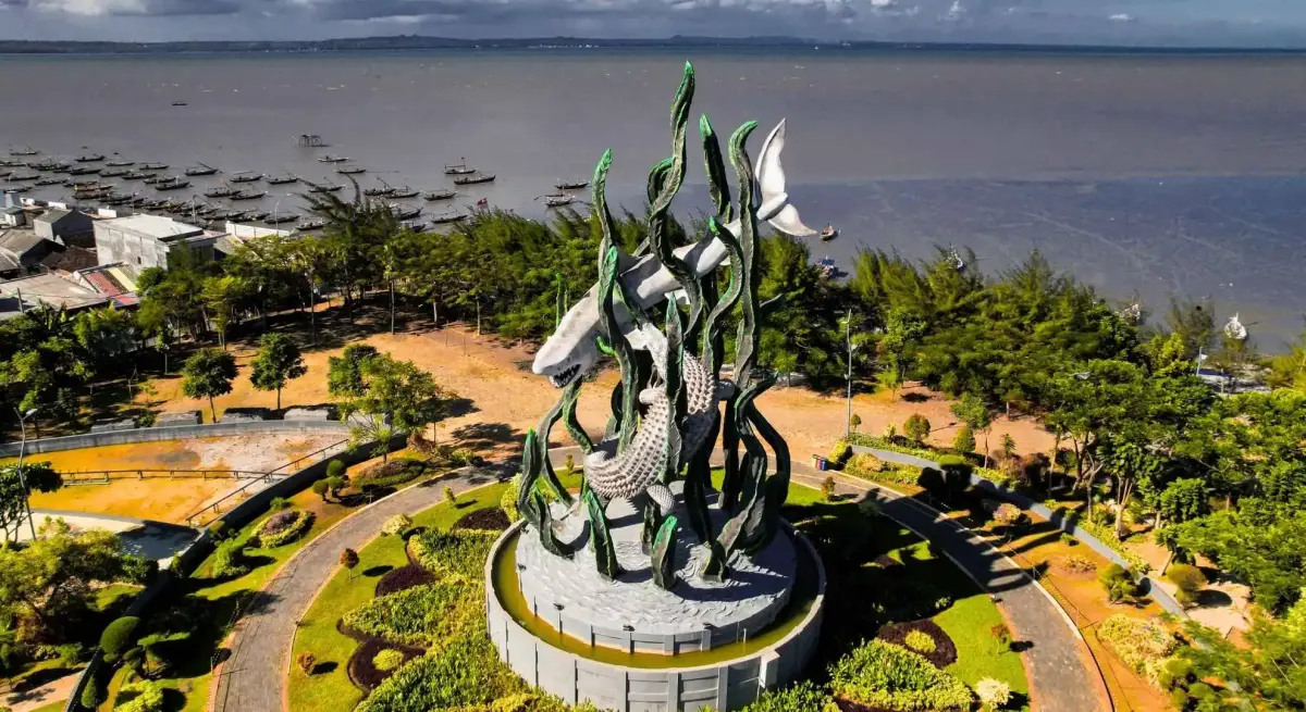 Aerial view of the Sura and Baya shark-and-crocodile monument in Surabaya, Indonesia, accessible via private jet charter