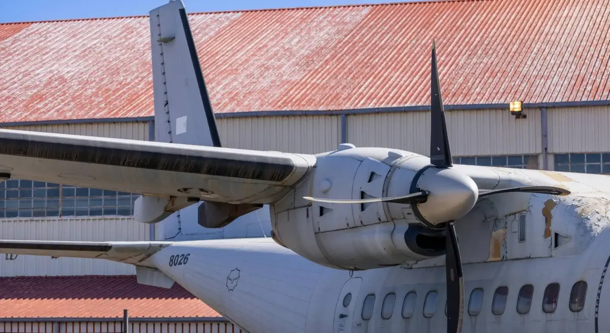 Turboprop aircraft parked outside a hangar, illustrating regional aircraft considerations for Jakarta to Batulicin charters