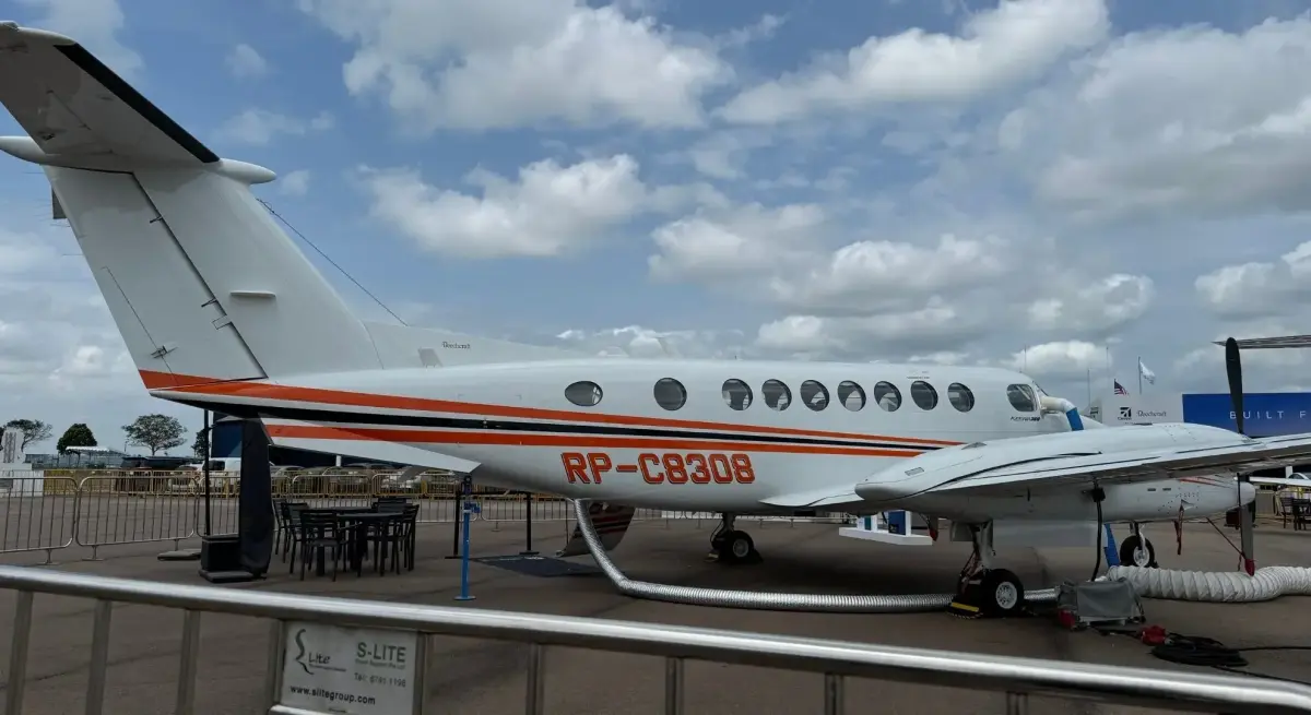 White business jet with orange stripes displayed at Singapore Airshow showcasing luxury aviation technology