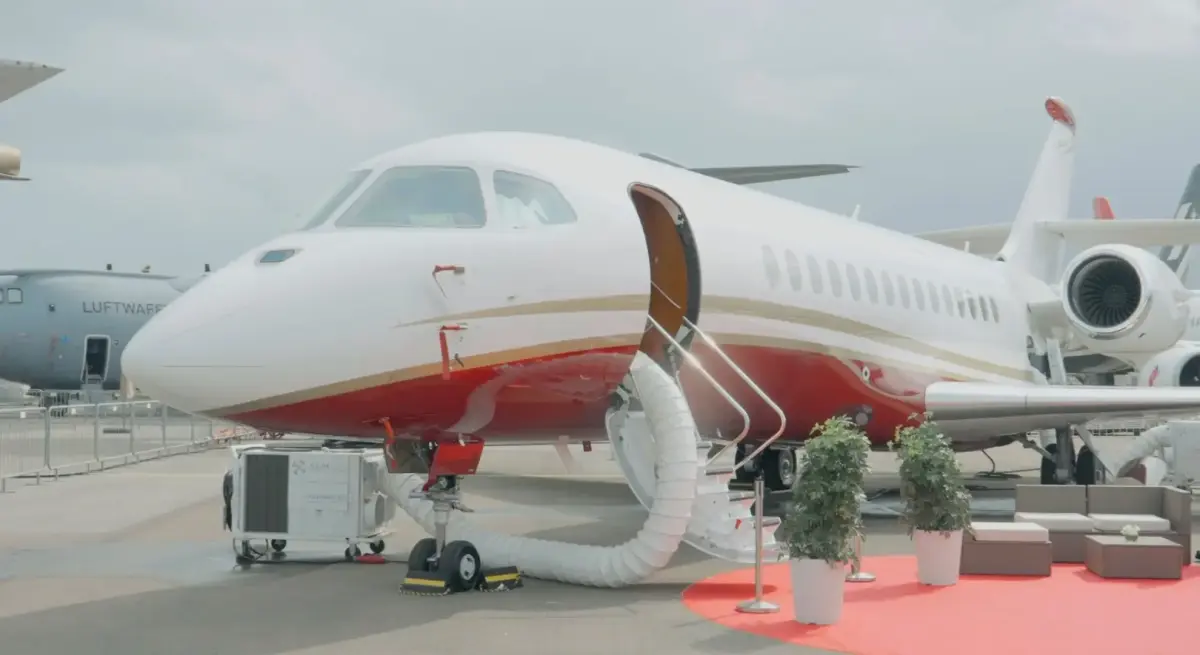 White and red private jet with open cabin door displayed at Singapore Airshow aviation exhibition