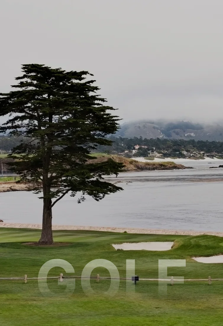 Scenic Pebble Beach golf course with pristine green fairways, sand bunkers, and Pacific Ocean coastline