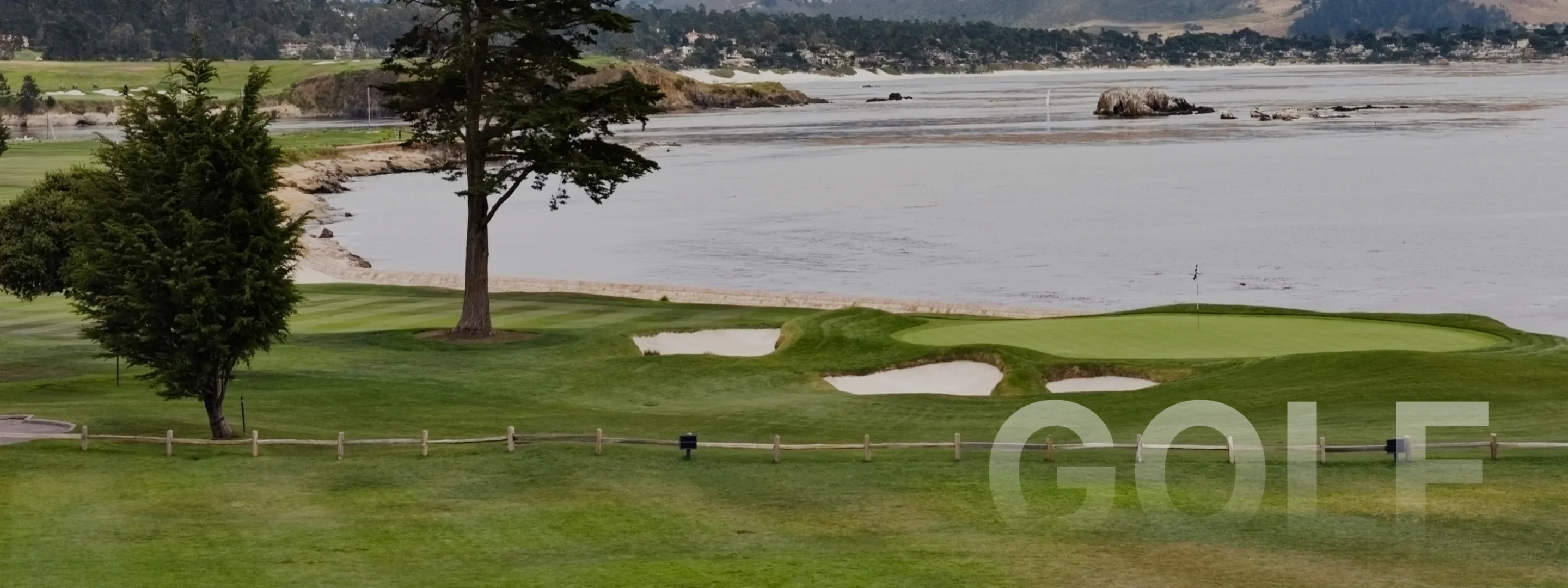 Scenic Pebble Beach golf course with pristine green fairways, sand bunkers, and Pacific Ocean coastline