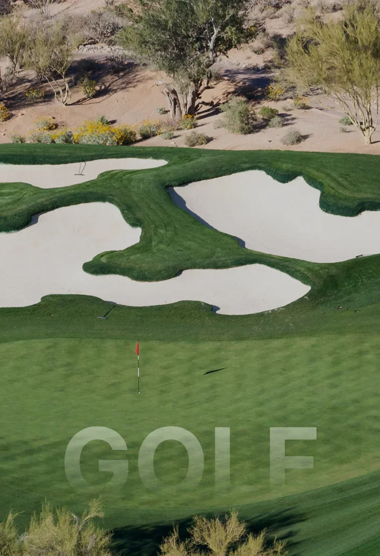 Aerial view of pristine Scottsdale golf course with manicured greens, sand bunkers and desert landscape
