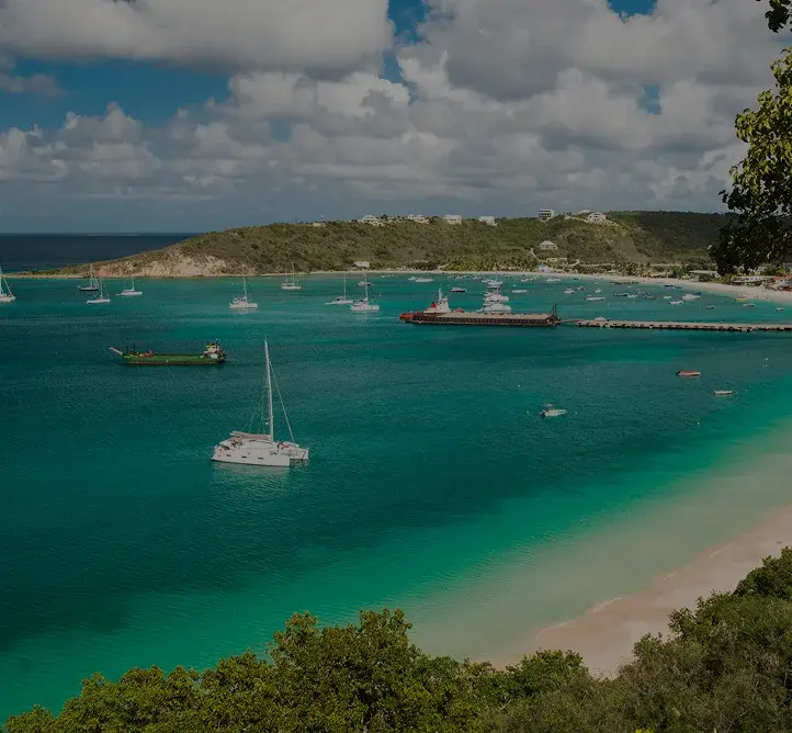 Pristine turquoise waters and white sand beach of Anguilla with luxury yachts anchored in protected bay
