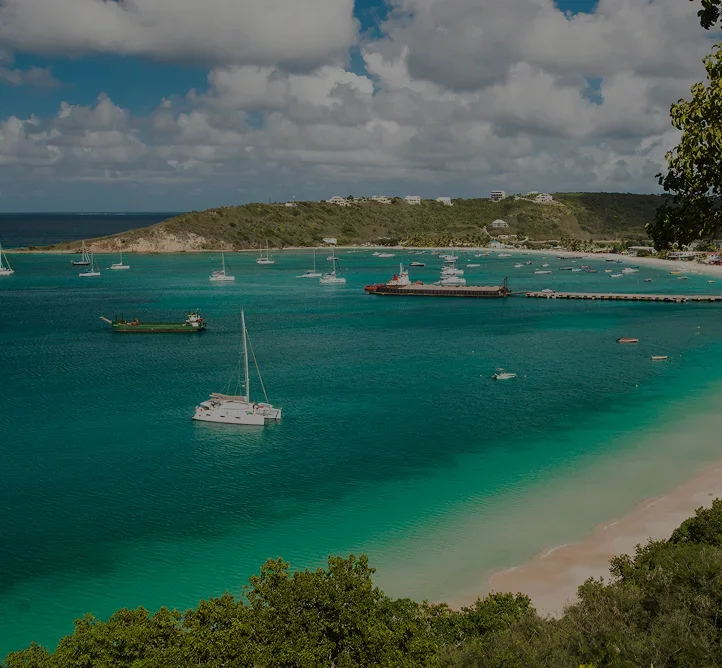 Pristine turquoise waters and white sand beach of Anguilla with luxury yachts anchored in protected bay