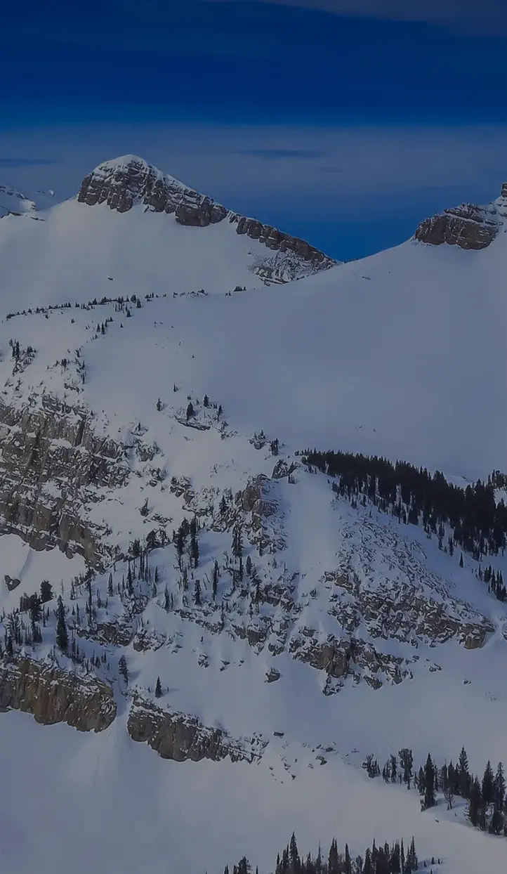 Snow-covered mountain peaks and alpine terrain of Jackson Hole ski resort destination for luxury travel