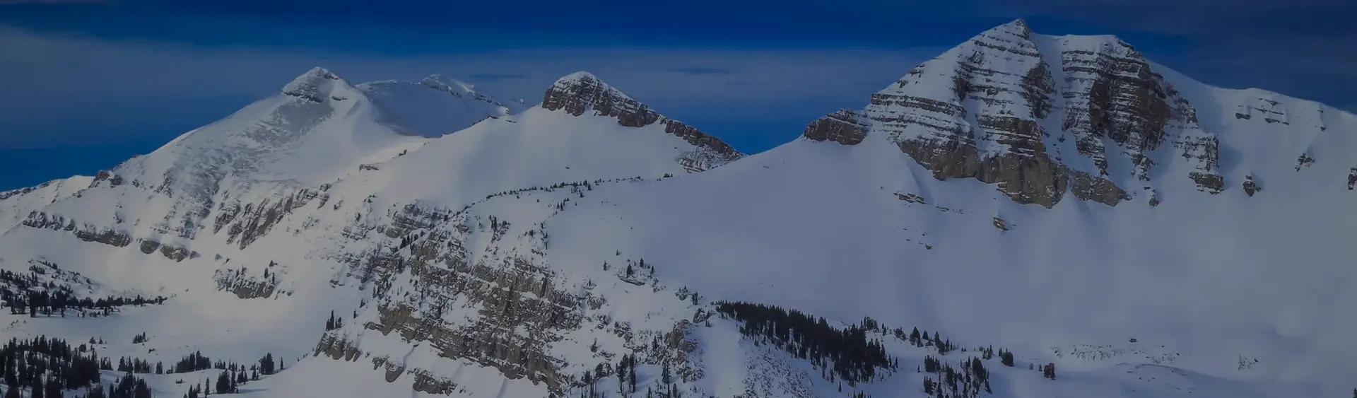 Snow-covered mountain peaks and alpine terrain of Jackson Hole ski resort destination for luxury travel