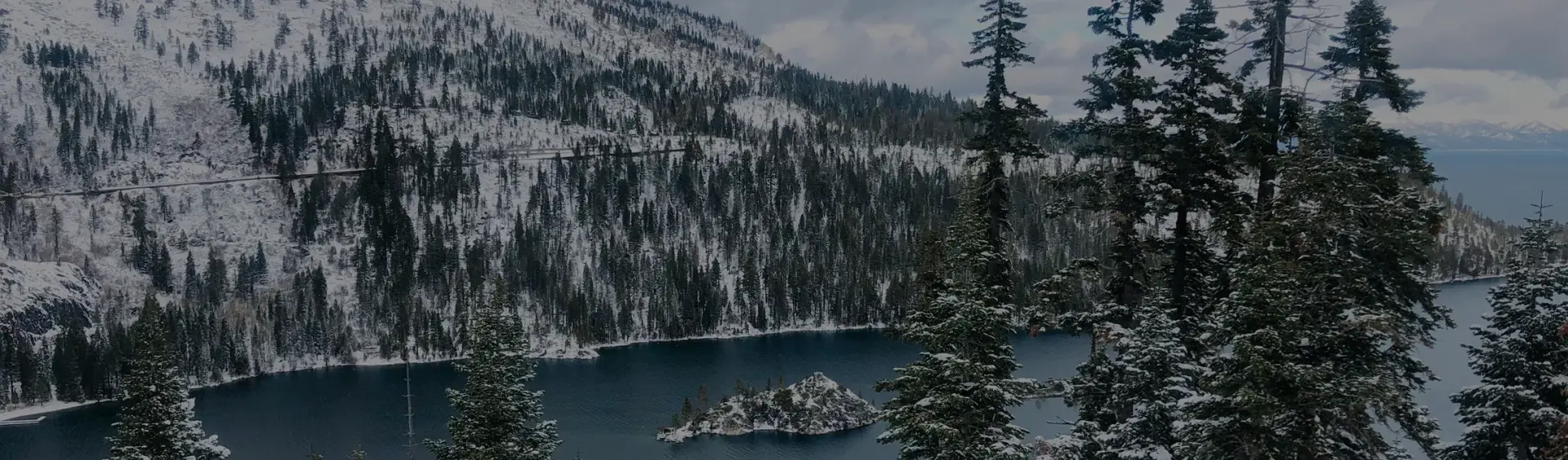 Snow-covered Lake Tahoe surrounded by pristine alpine forests and mountain peaks, a premier ski destination