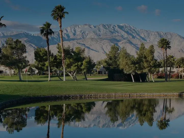 Pristine golf course fairway in Palm Springs with snow-capped San Jacinto Mountains backdrop