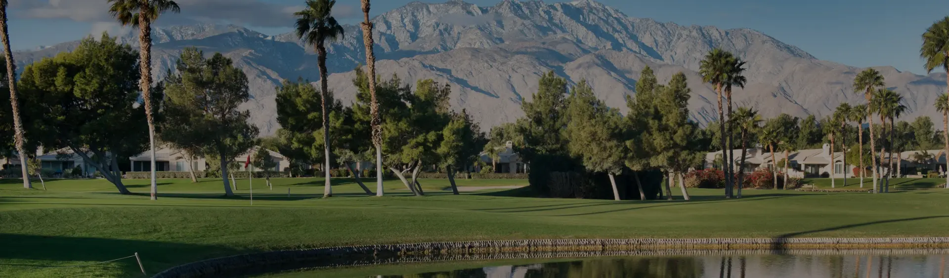 Pristine golf course fairway in Palm Springs with snow-capped San Jacinto Mountains backdrop