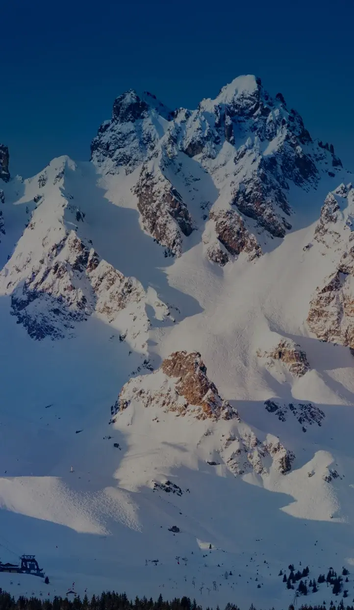 Snow-covered mountain peaks of Sun Valley ski resort under clear blue skies, premier destination for luxury skiing
