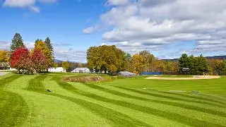 Pristine golf course with manicured fairways and autumn foliage under blue skies in Scottsdale