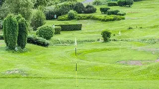 Pristine golf course with manicured greens, flag markers, and lush landscaping in Scottsdale