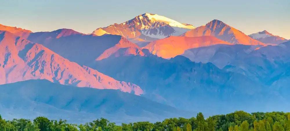 Majestic Andes mountains bathed in golden sunrise light overlooking Argentina's dramatic landscape