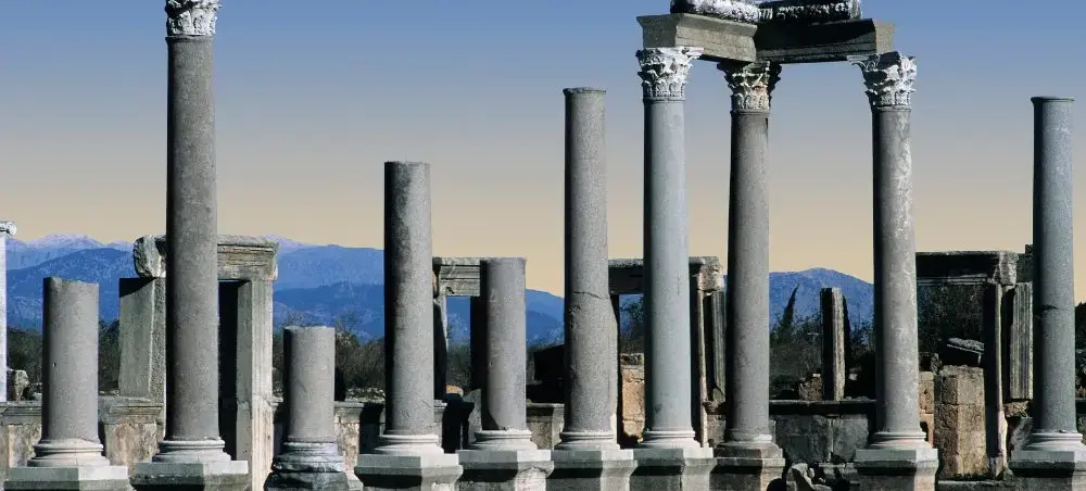 Ancient Roman columns and ruins at Perge archaeological site near Antalya with Taurus Mountains backdrop