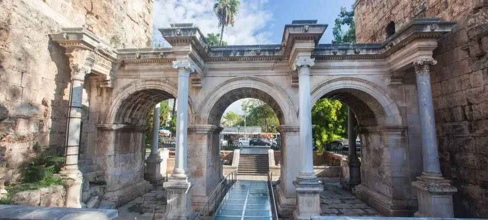 Ancient Roman Hadrian's Gate with triple arches and marble columns in historic Antalya, Turkey