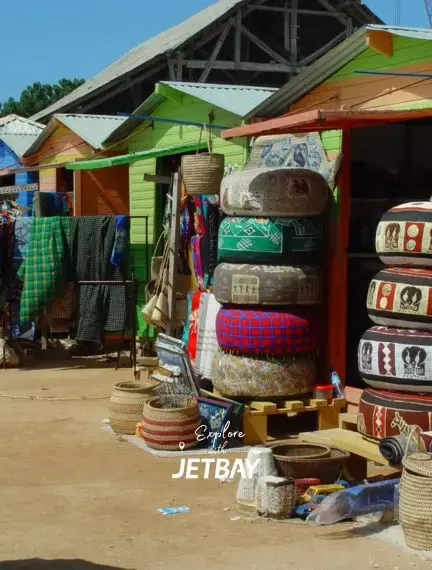 Vibrant local market stalls in Arusha displaying traditional Tanzanian crafts and colorful textiles