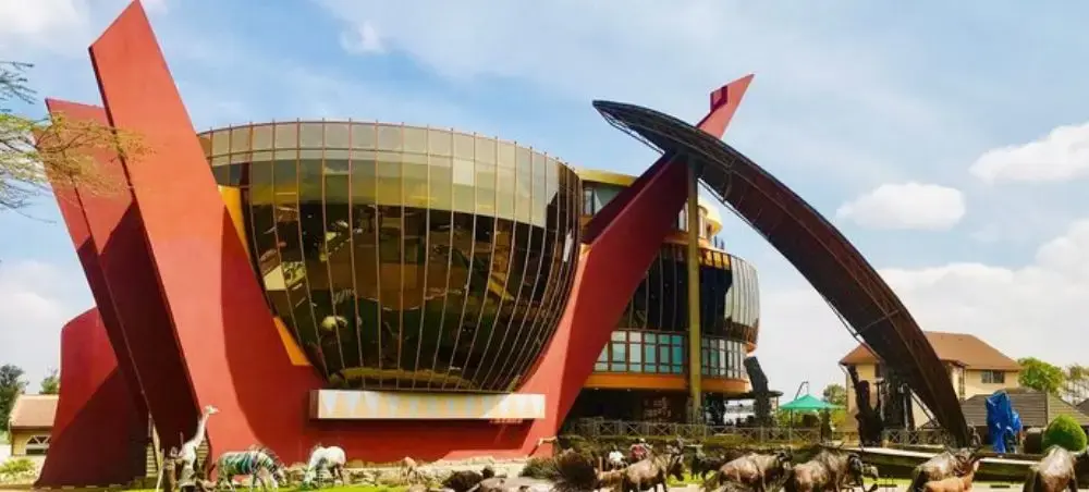 Modern cultural center in Arusha featuring distinctive curved architecture and red sculptural elements