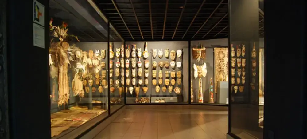 Museum exhibition displaying traditional Paraguayan indigenous artifacts and ceremonial masks in Asuncion