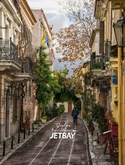 Charming cobblestone street in Athens old town with traditional Greek architecture and autumn foliage