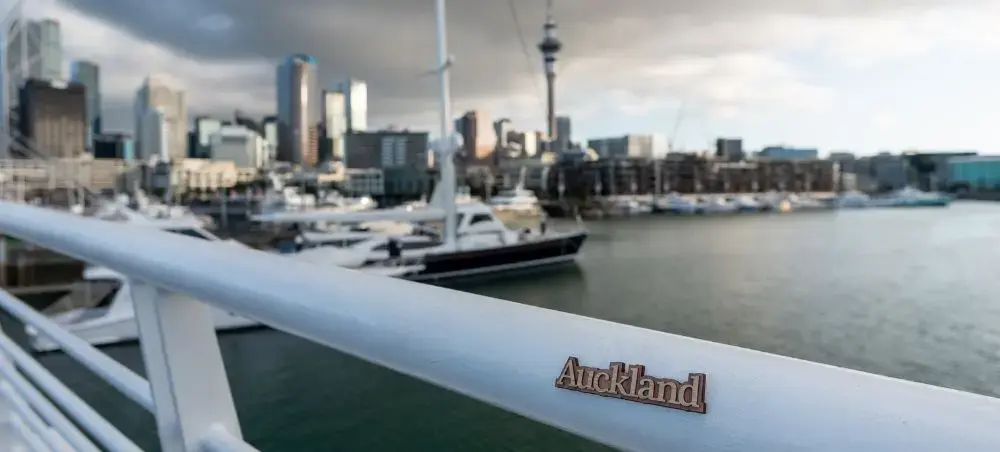 Auckland harbor view from yacht deck with city skyline, Sky Tower, and luxury marina for private jet travelers
