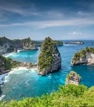 Dramatic limestone cliffs and turquoise lagoons showcase Bali's pristine coastline for luxury travelers