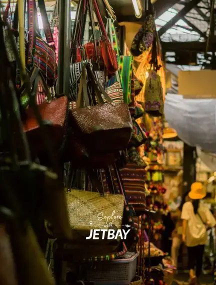Colorful handwoven bags and traditional Thai crafts displayed at vibrant Bangkok street market stall
