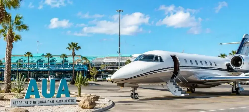 Beach resort and clear coastal waters in Aruba on a private jet charter itinerary