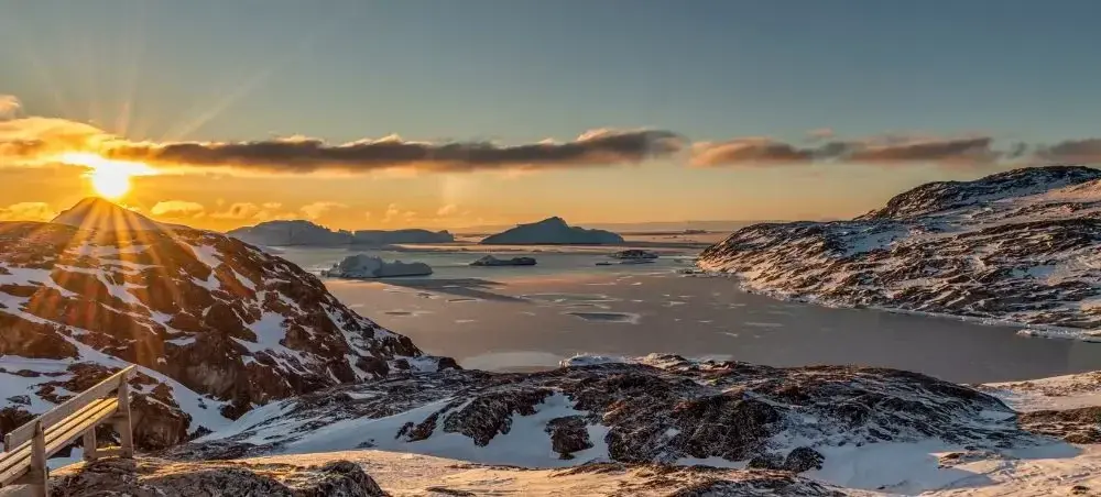 Beach resort and clear coastal waters in Ilulissat on a private jet charter itinerary
