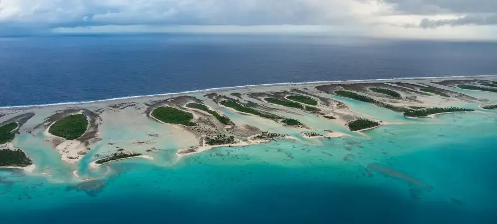 Beach resort and clear coastal waters in Rangiroa on a private jet charter itinerary