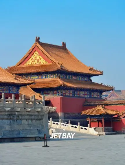 Traditional Chinese palace architecture with ornate golden roofs and marble balustrades in Beijing's Forbidden City