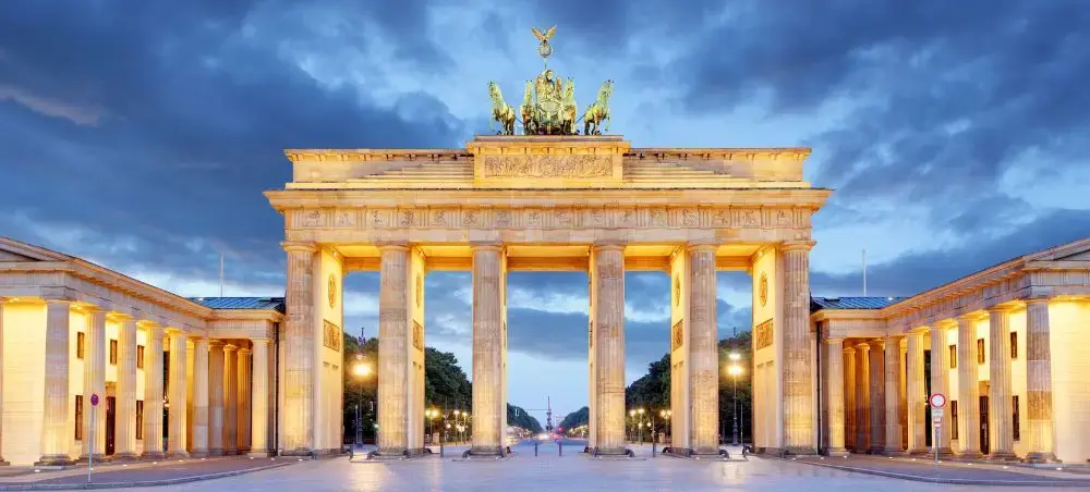 Brandenburg Gate illuminated at dusk showcasing Berlin's iconic neoclassical architecture and Germany's capital