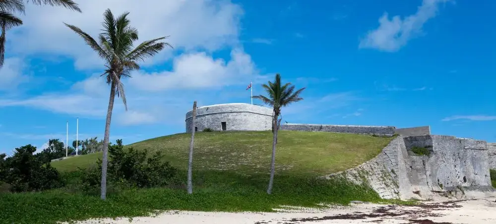 Historic Royal Naval Dockyard fortifications in Bermuda surrounded by palm trees and pristine beaches