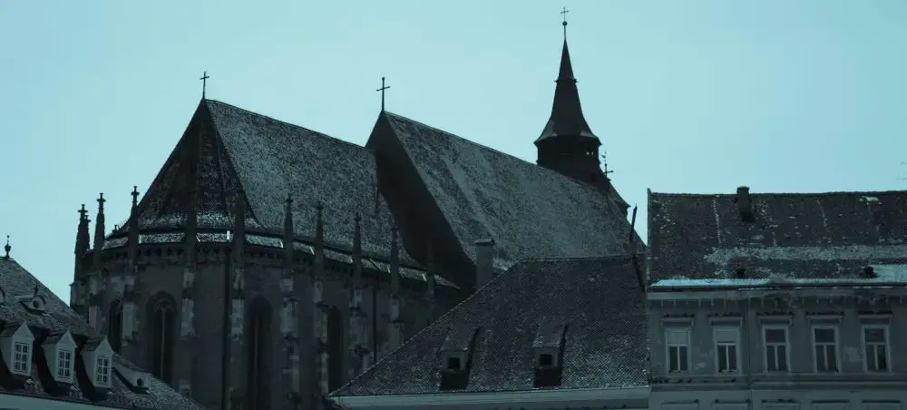 Historic Black Church with Gothic spires and traditional rooftops in Brasov's medieval old town center